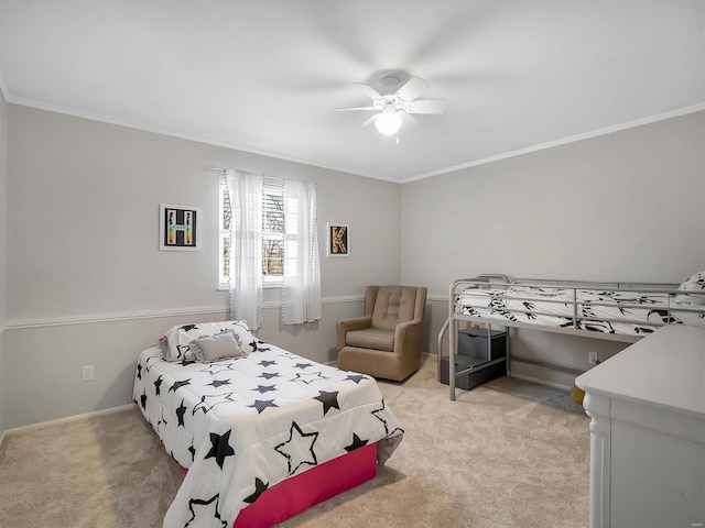 bedroom featuring ceiling fan, crown molding, baseboards, and light carpet