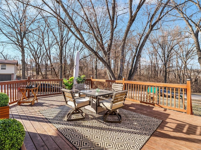 wooden terrace with outdoor dining space