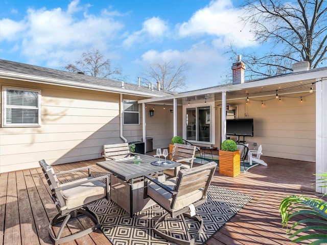 wooden deck with outdoor dining area