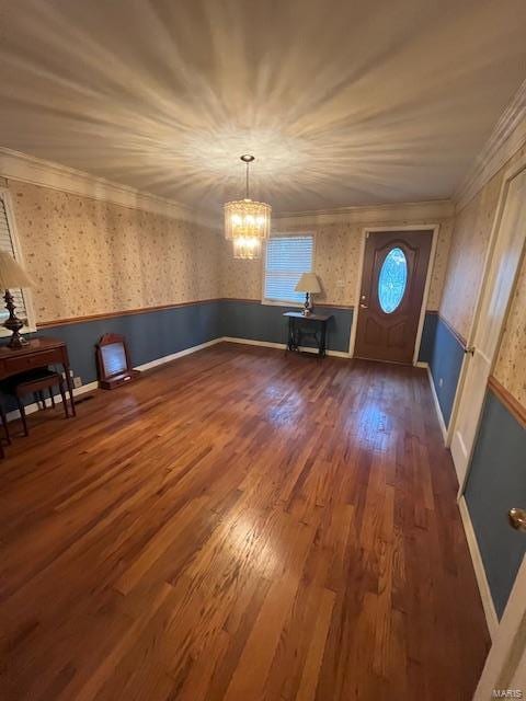 interior space with crown molding, an inviting chandelier, and dark wood-type flooring