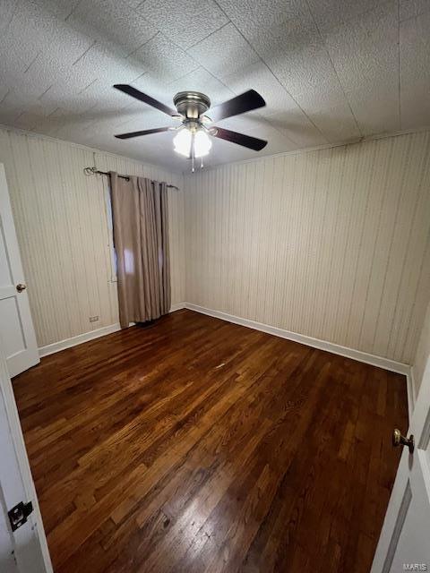 empty room with wood-type flooring and ceiling fan