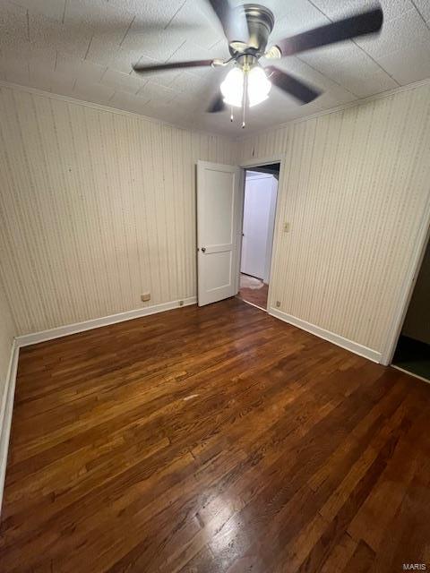 unfurnished room with dark hardwood / wood-style floors and ceiling fan