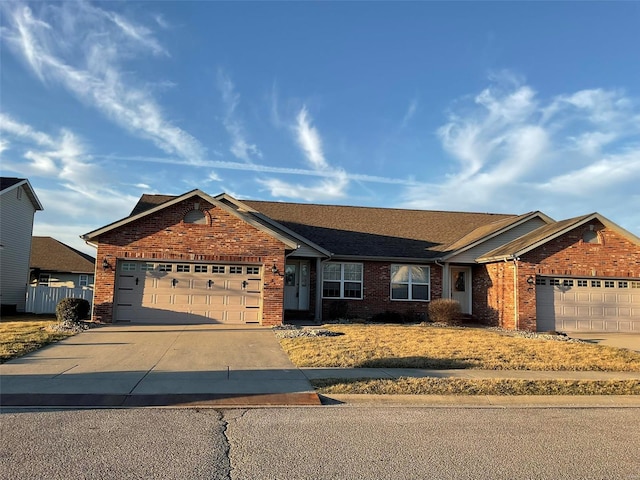 single story home with a garage, concrete driveway, and brick siding