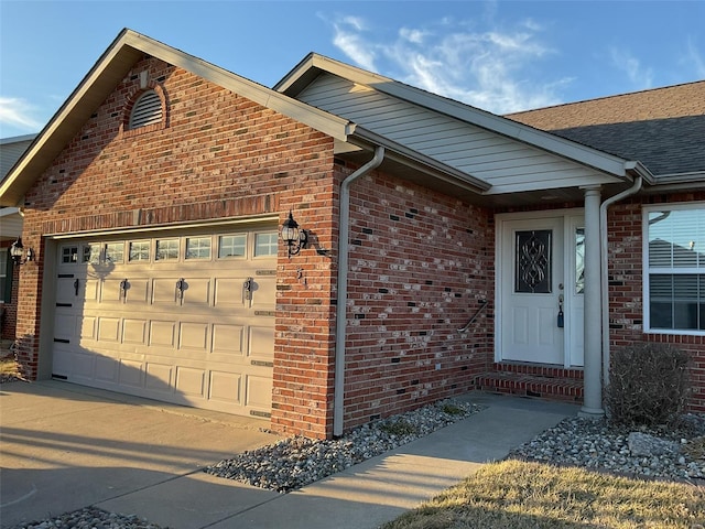 view of front of home featuring a garage and brick siding