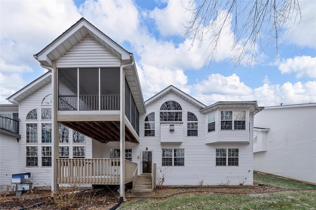 rear view of house featuring a deck and a sunroom