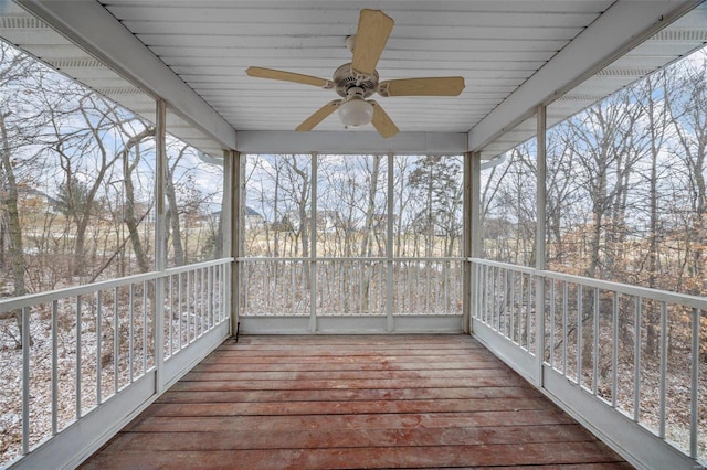 unfurnished sunroom with ceiling fan