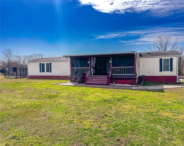 manufactured / mobile home with a front yard and a sunroom