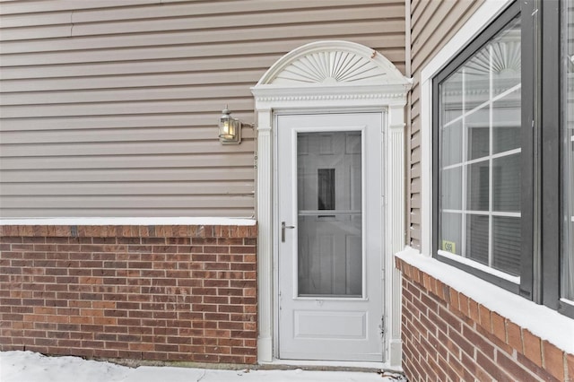 view of snow covered property entrance