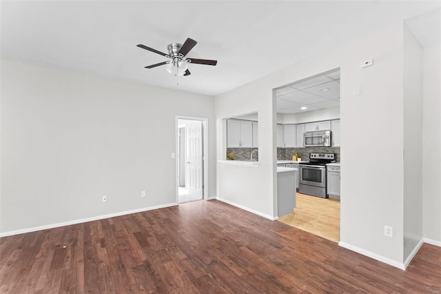 unfurnished living room with hardwood / wood-style flooring and ceiling fan