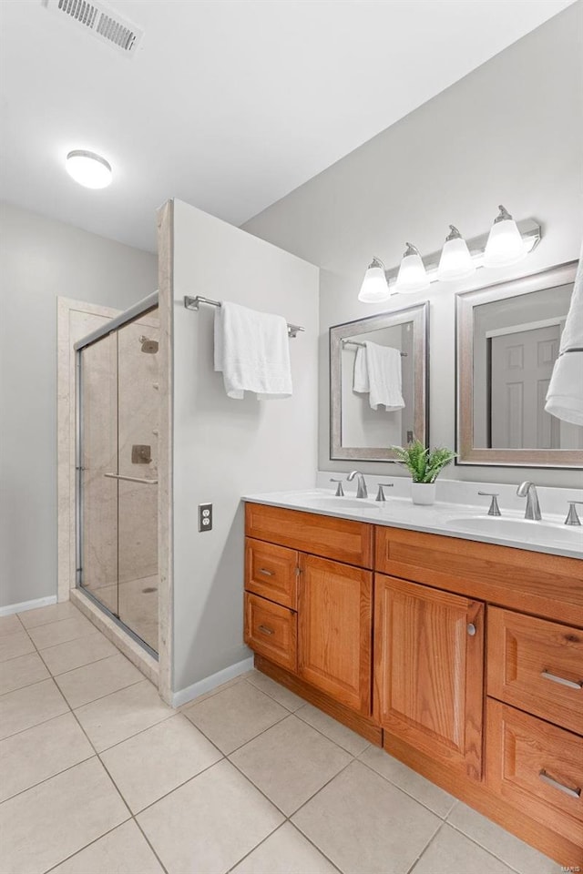 bathroom with an enclosed shower, tile patterned flooring, and vanity