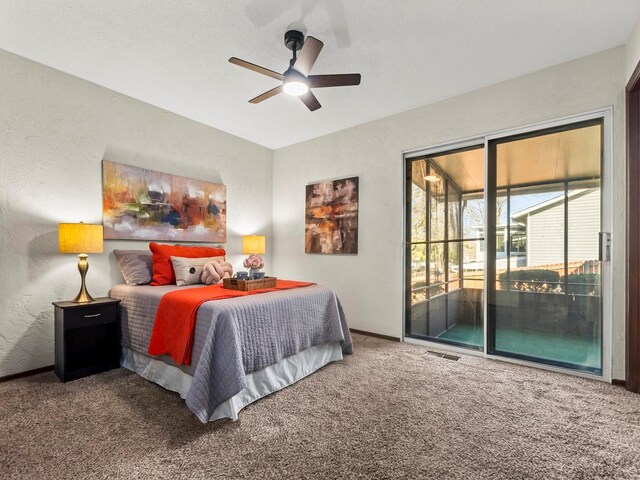 carpeted bedroom with a textured wall, visible vents, ceiling fan, and access to outside