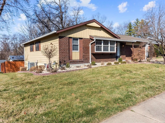 ranch-style home with central air condition unit, brick siding, a front yard, and fence