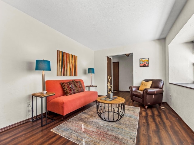 living area with a textured ceiling and wood finished floors