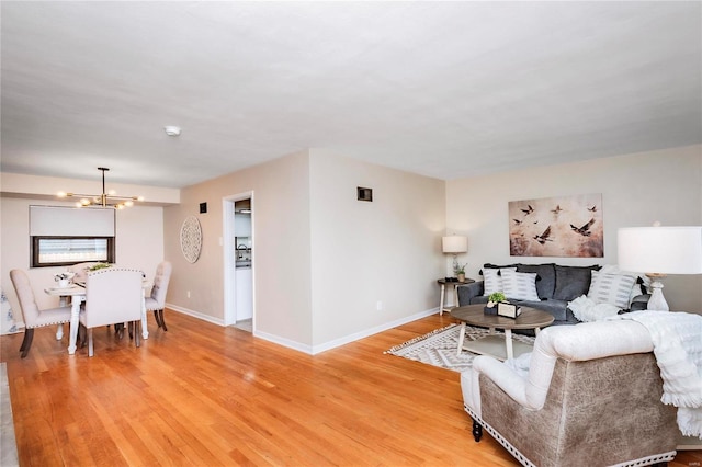 living room featuring hardwood / wood-style floors and an inviting chandelier