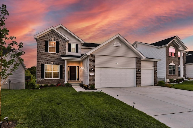 front of property with a lawn and a garage