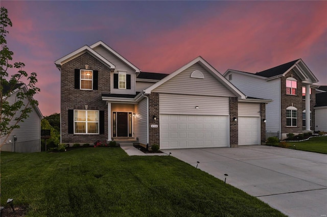 front facade featuring a garage and a yard