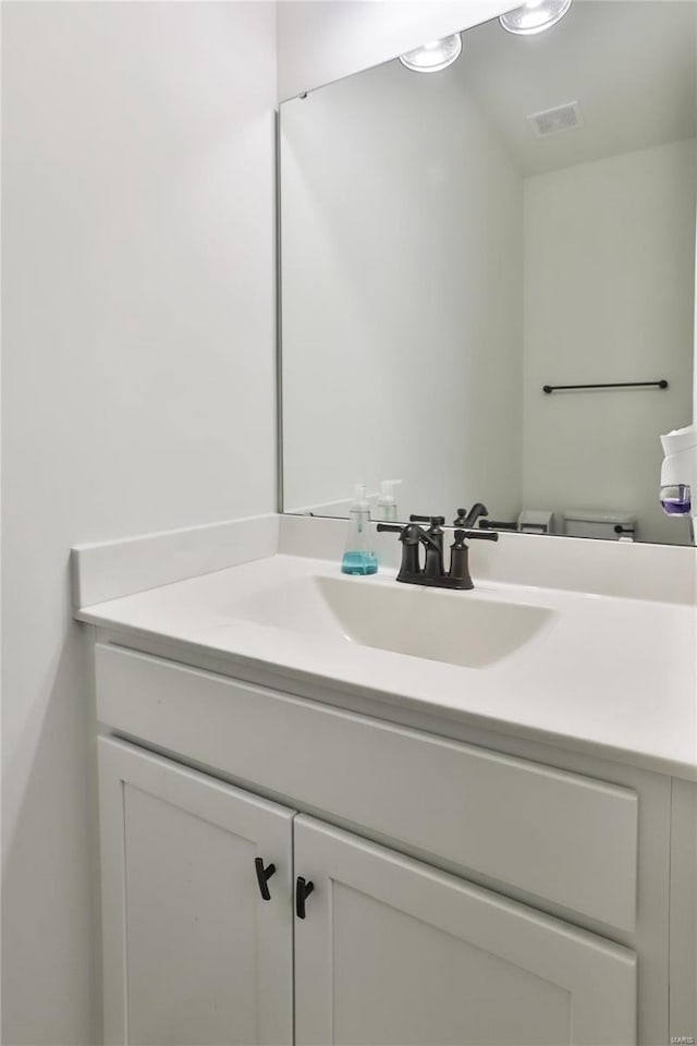 bathroom with toilet and vanity