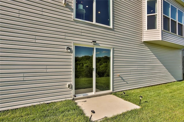 view of side of home featuring a lawn