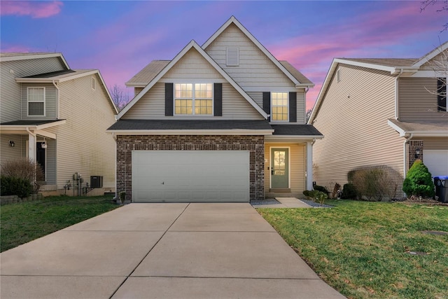 view of front facade featuring brick siding, an attached garage, a shingled roof, a front lawn, and driveway