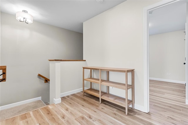 spare room with baseboards and wood finished floors