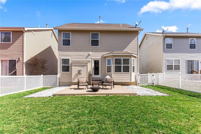 rear view of house with a yard, a patio area, and a fenced backyard