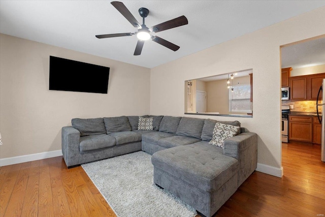 living room with ceiling fan and wood-type flooring