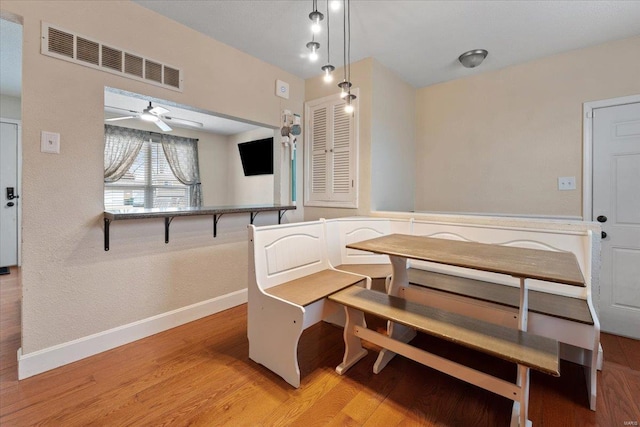 dining area featuring ceiling fan, wood-type flooring, and breakfast area