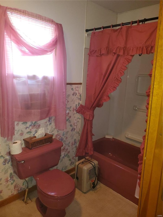 bathroom featuring shower / bathtub combination with curtain and toilet