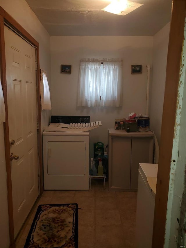 laundry room with washer / clothes dryer, cabinets, and light tile patterned floors