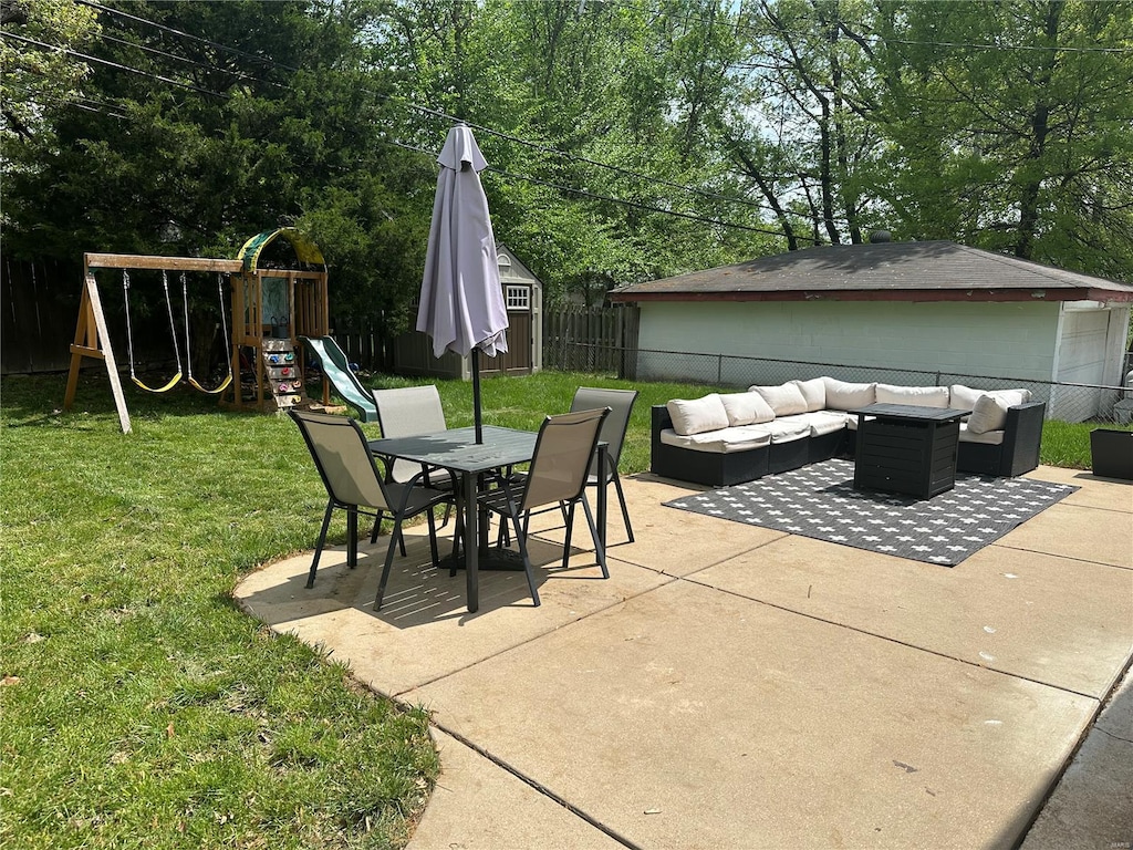 view of patio featuring a fenced backyard, outdoor dining area, an outdoor hangout area, and a playground
