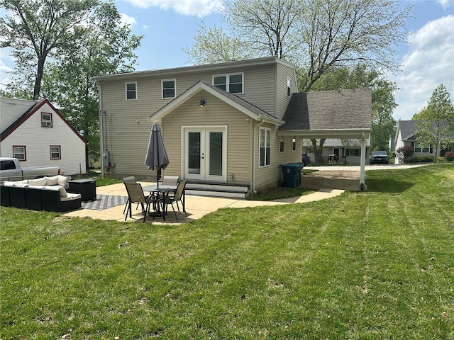 rear view of house featuring an attached carport, outdoor lounge area, a patio area, french doors, and a yard