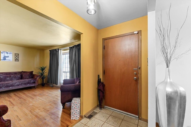 entrance foyer with baseboards and light wood-style flooring