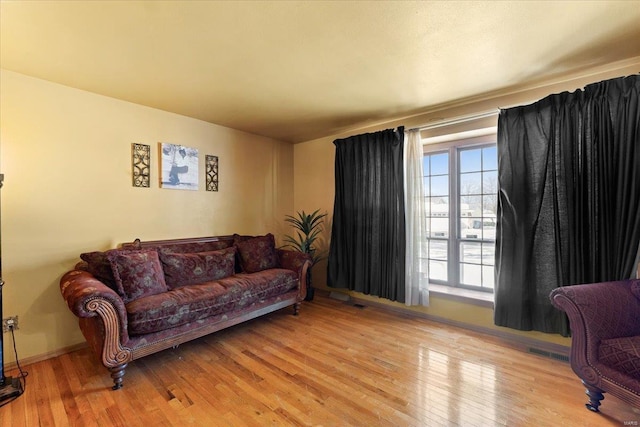 living area featuring visible vents and wood-type flooring