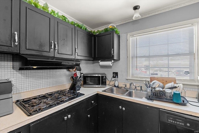 kitchen featuring under cabinet range hood, light countertops, decorative backsplash, dark cabinetry, and black appliances