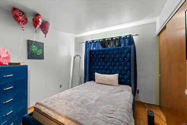 bedroom featuring wood finished floors