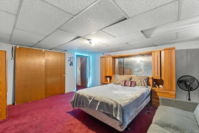 carpeted bedroom featuring a paneled ceiling