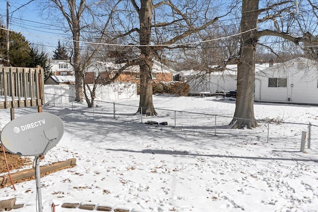 yard layered in snow featuring fence