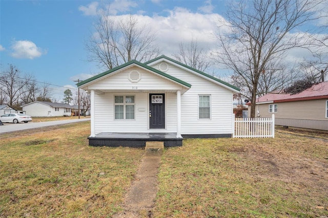 bungalow featuring covered porch and a front yard