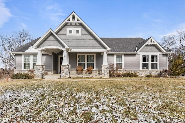 craftsman house with a yard and a porch