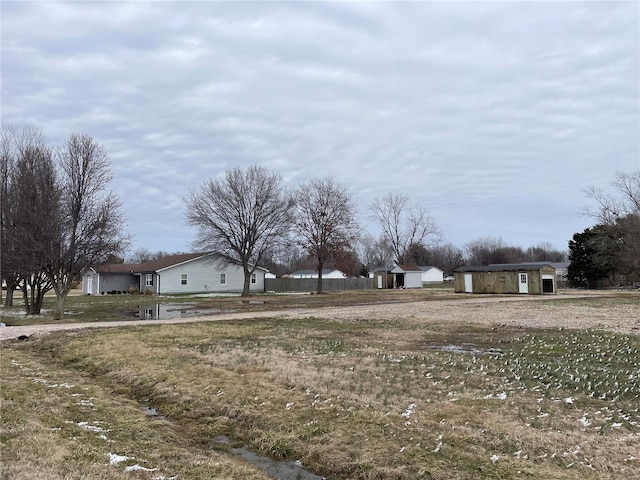 view of yard with a storage unit