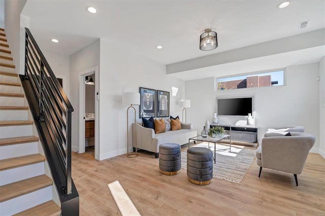 living room featuring stairway, recessed lighting, visible vents, and light wood-style floors