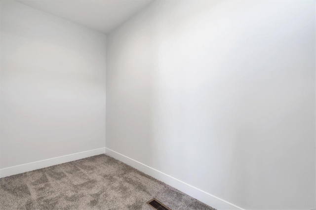 unfurnished room with visible vents, baseboards, and light colored carpet