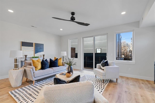 living area featuring a ceiling fan, recessed lighting, light wood-style flooring, and baseboards