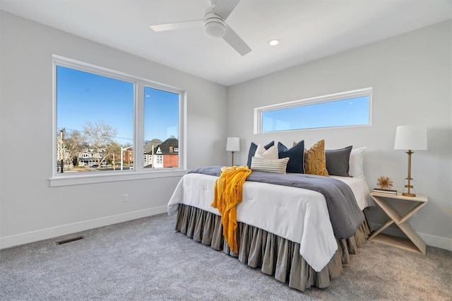 carpeted bedroom with a ceiling fan, recessed lighting, visible vents, and baseboards