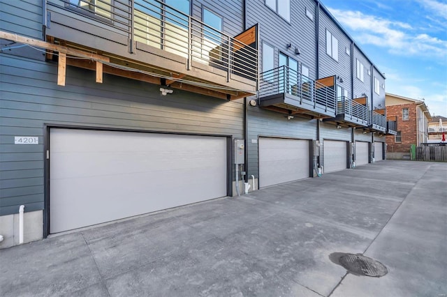 view of home's exterior featuring a garage and a balcony