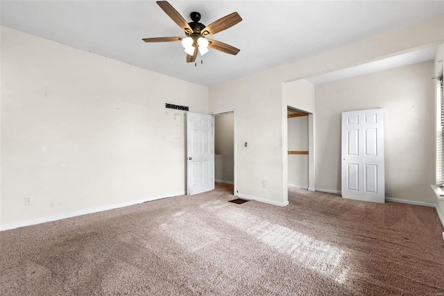 unfurnished bedroom with carpet floors, a ceiling fan, and baseboards