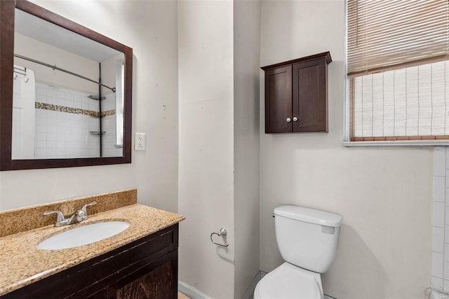 bathroom with vanity, toilet, and walk in shower