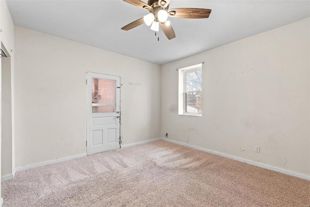 empty room with carpet floors, ceiling fan, and baseboards