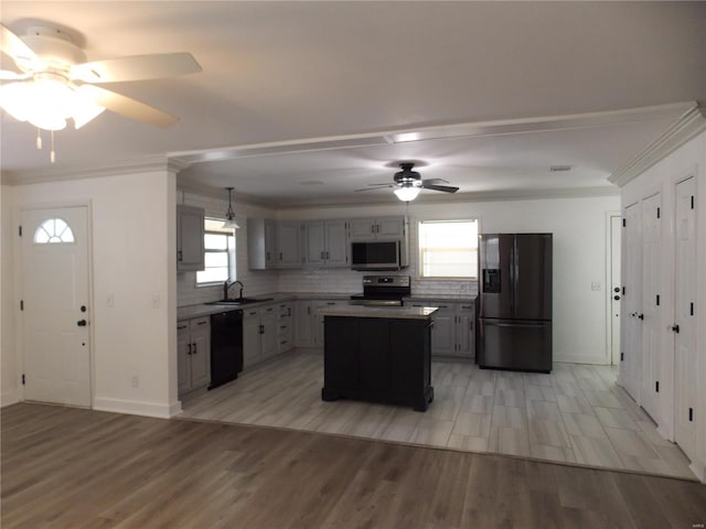 kitchen featuring gray cabinets, a kitchen island, crown molding, and black appliances