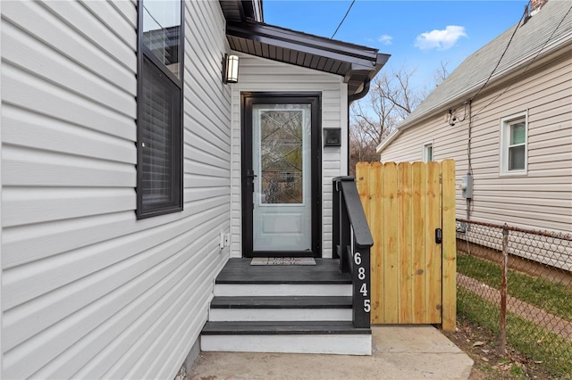 entrance to property featuring fence